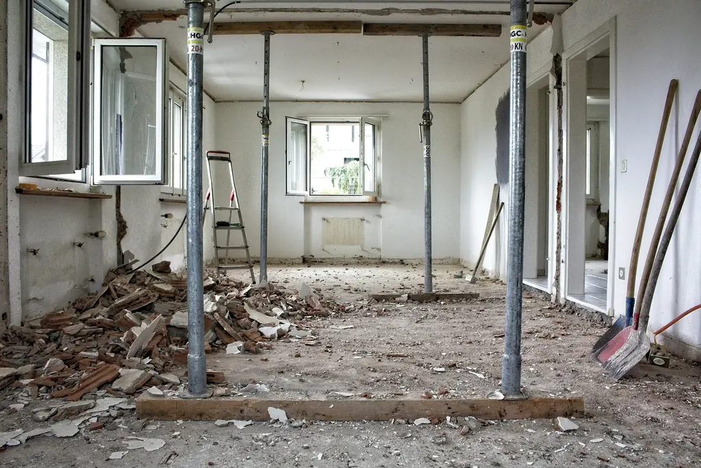 Interior de un inmueble en plena remodelación, con puntales y escombro